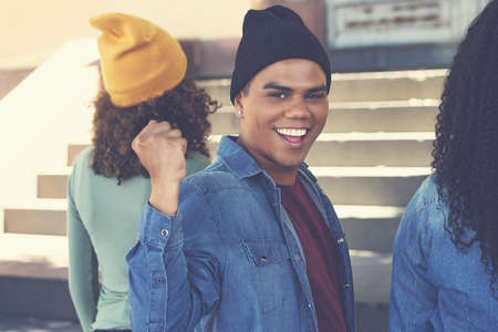 Cheering latin american hipster young adult with group of friends outdoor in urban city styleの写真素材