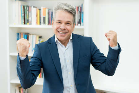 Successful mature businessman with competence and self-confidence at office of companyの写真素材