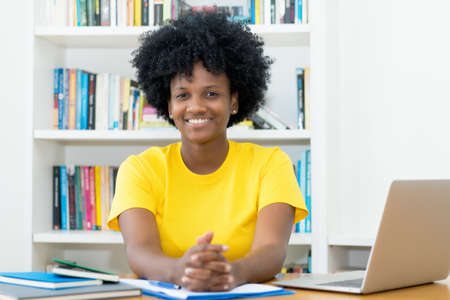 Portrait of african american female student indoors at desk at home indoors at desk at homeの写真素材