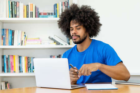 African american software engineer at work at computer at office of start up companyの写真素材