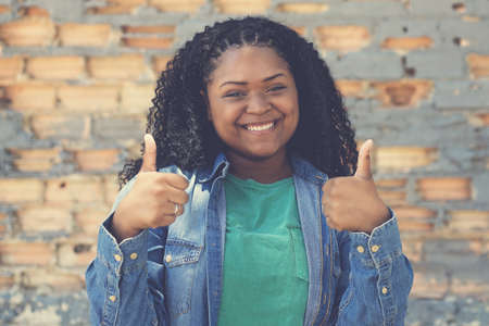 Optimistic corpulent african american female young adult outdoor in urban city styleの写真素材