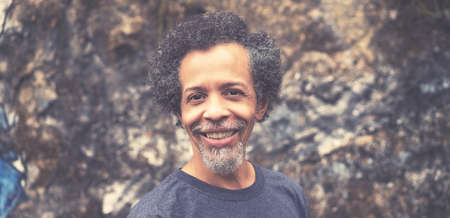 Laughing african american mature adult man with grey hair and beard outdoor in urban city stayleの写真素材