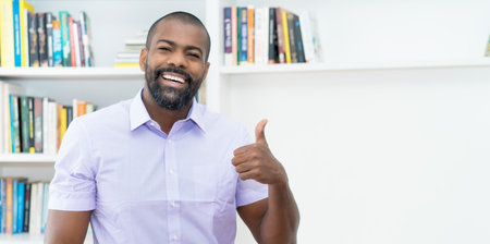 Successful african american businessman with beard indoors at officeの写真素材