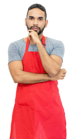 Serious latin american clerk or waiter or chef with red apron isolated on white background for cut outの写真素材