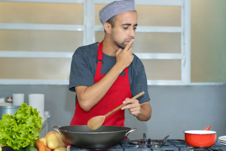 Egyptian chef preparing traditional food at kitchen of restaurantの写真素材
