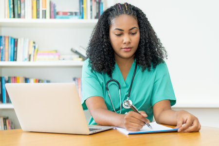 Latin american medical student or female nurse working at office at hospitalの写真素材