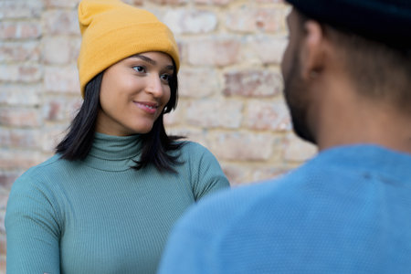 Pretty latin american woman flirting with boyfriend outdoor in the cityの写真素材