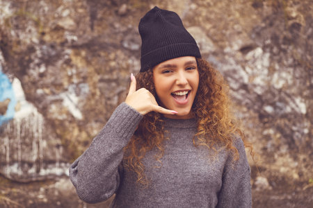 Hipster girl with knit hat - concept contact me in urban styleの写真素材