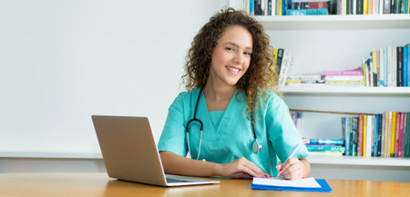 Laughing medical student or female nurse at work at hospital with copy spaceの写真素材