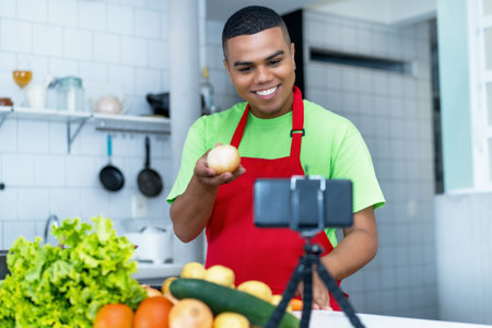 Laughing latin american food blogger streaming video clip of cooking healthy food with tomatoes and potatoes and saladの写真素材