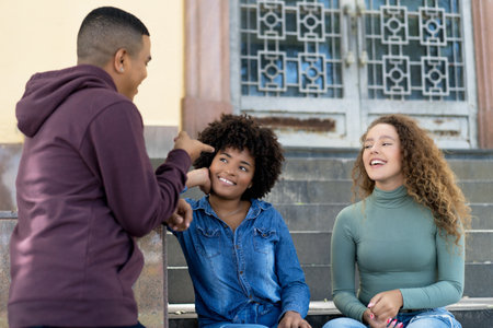 Group of hispanic and caucasian and african american young adults in discussion outdoor in the cityの写真素材