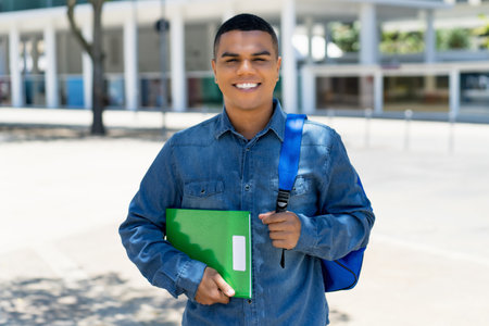 Laughing mexican male student with backpack at campus of universityの写真素材
