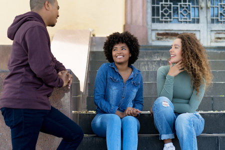 Group of happy hispanic and caucasian and african american young adults outdoor in the cityの写真素材