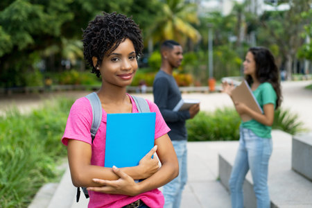 Young brazilian female student with group of friends outdoor in tropical cityの写真素材