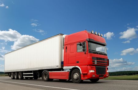 Single red lorry with white trailer over blue sky on the road. See other vans and trucks in my portfolioの写真素材