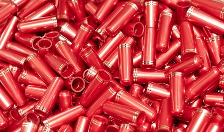 heap of red caps with golden strips for cosmetics