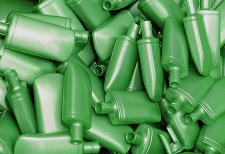 Heap of green nacreous plastic bottles for cosmetics の写真素材
