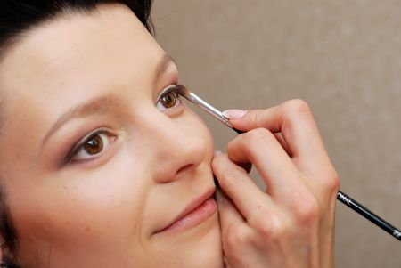 Make-up. Putting eye shadow on eyelid with brushの写真素材
