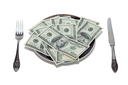 Plate full of dollars with knife and fork on each sideの写真素材