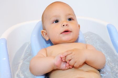 close-up portrait of Baby lying in the bath with waterの写真素材