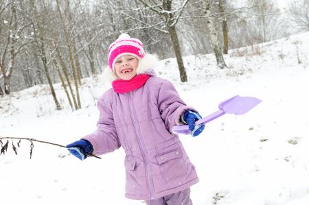 little happy girl laughing at snowy winter outdoorsの写真素材