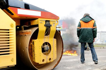 Heavy yellow roller compactor involving in fire extinguishing
