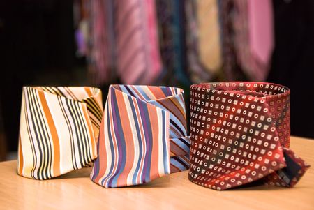 three colorful man's ties lying on a tableの写真素材