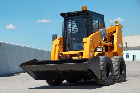 skid steer loader construction machine with bucket outdoors