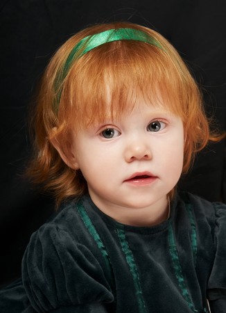 portrait of a Cheerful Little smiling red-haired girl の写真素材