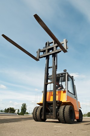 Heavy Forklift loader for warehouse works outdoors with risen forksの写真素材