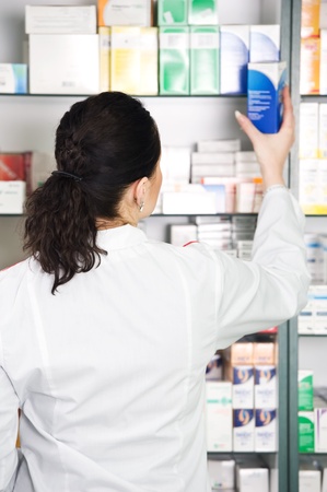 pharmacist chemist woman working in pharmacy drugstoreの写真素材
