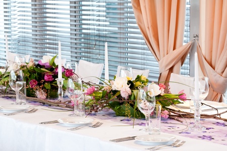 catering table set service with silverware, fresh flowers and glass at restaurant before party