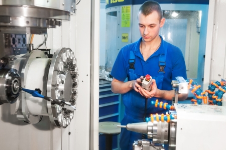 mechanical technician operative of cnc milling cutting machine center at tool workshop