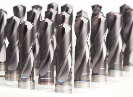 heap of finished metal drill tools with protective coating
