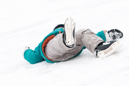 physical injury of little child boy during winter sport skatingの写真素材