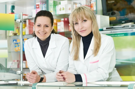 Two Pharmacy chemist women in drugstoreの写真素材