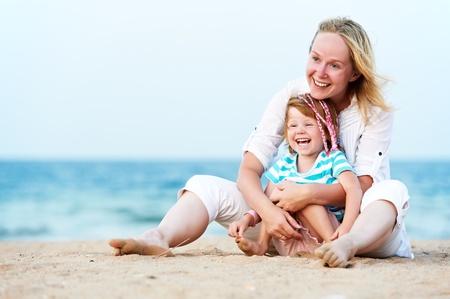 Woman and child at sea beachの写真素材