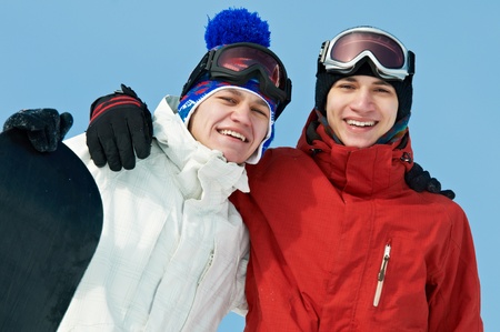 Happy sportsman with snowboardsの写真素材