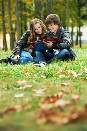 Two smiling young students outdoorsの写真素材