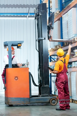 warehouse works (forklift and workers)の写真素材