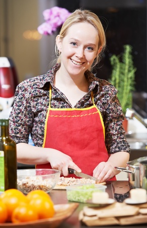 smiling woman cooking in her kitchenの写真素材