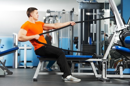 bodybuilder man doing exercises in fitness club