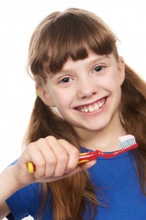 Smiling little girl with toothpaste on toothbrushの写真素材