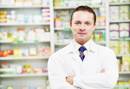 Confident pharmacy chemist man in drugstoreの写真素材