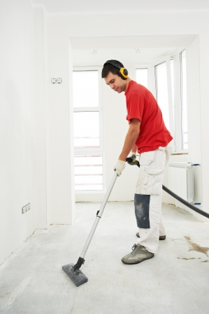 worker cleaning floor at home renovationの写真素材