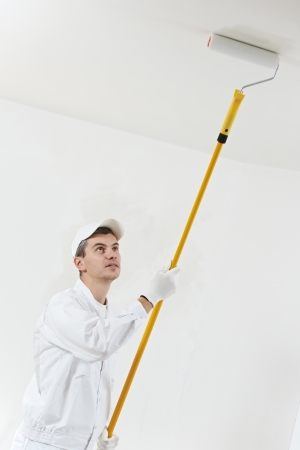 house painter at work with painting rollerの写真素材