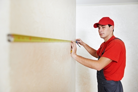 Handyman with measuring tapeの写真素材