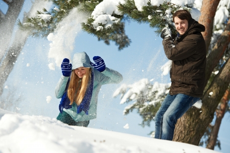 young peolple playing with snow in winterの写真素材