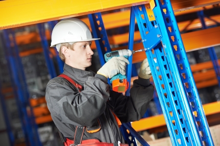 warehouse worker installing rack arrangement