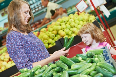 woman and little girl shopping fruitsの写真素材